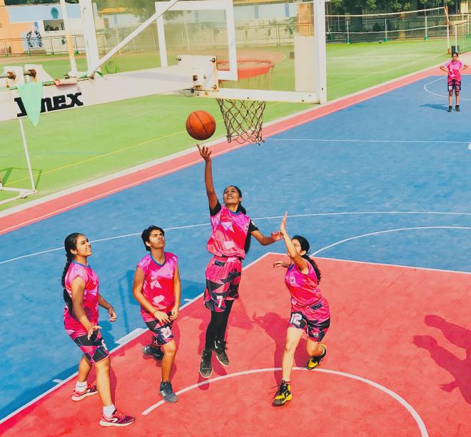 Girls Student-Athlete playing competitive basketball at IB Sports Academy.