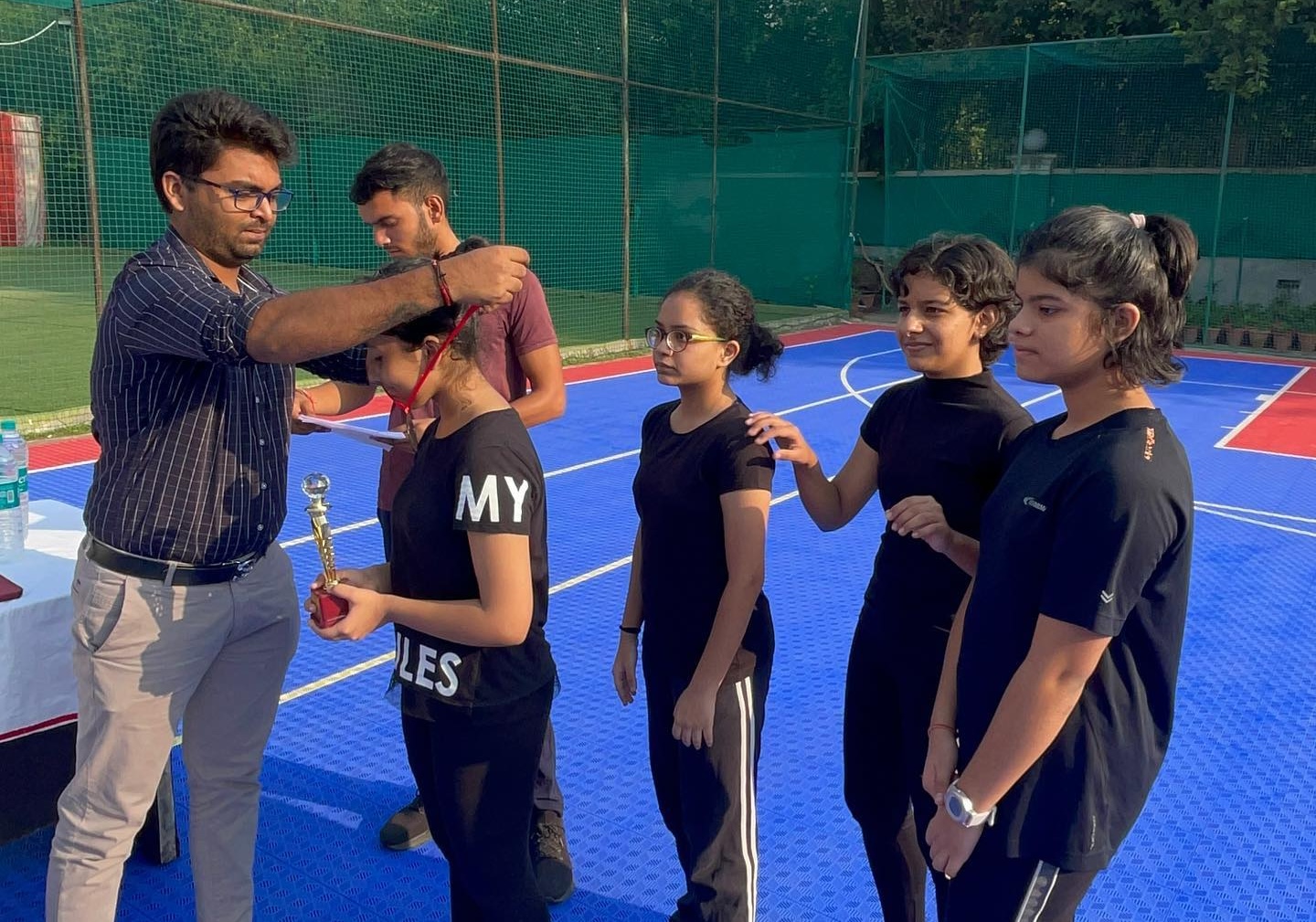 Coach Vishal Presenting Medals to the Winners During the Official Aerobics Prize Ceremony