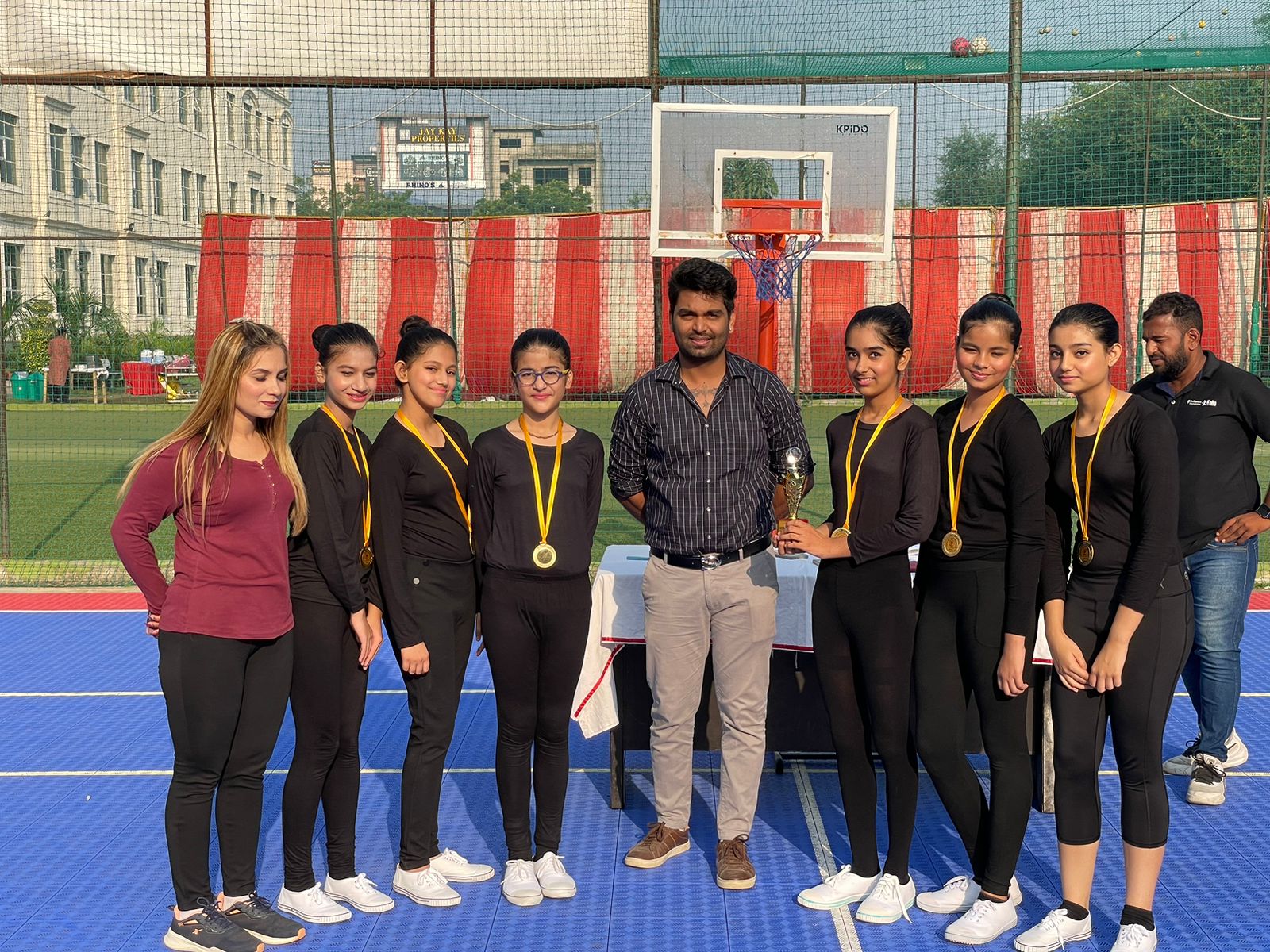 Student-Athletes Proudly Displaying Their Medals With Coach Vishal After the Aerobics Finals